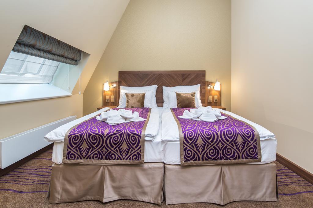 Merchants Crown Suites And Spa ปราก ภายนอก รูปภาพ A bed with a bed skirt